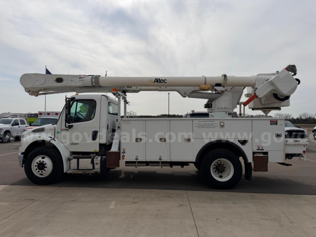 Altec AM55 bucket truck on Freightliner chassis side view showing bucket control area and boom arm with stabilizers.