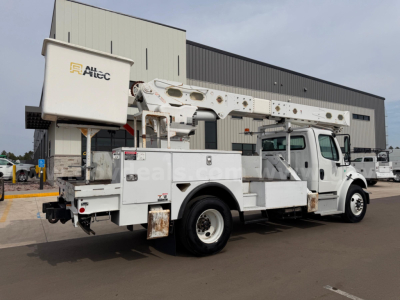 Truck-mounted bucket lift on Freightliner Altec AM55 in-service with bucket and utility body, side view, stock number 24329-497.