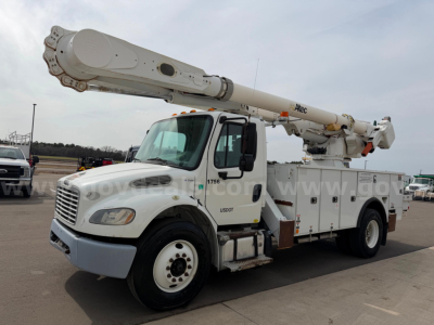 Bucket truck with extended boom on Freightliner chassis showing AM55 model equipment and utility compartments.