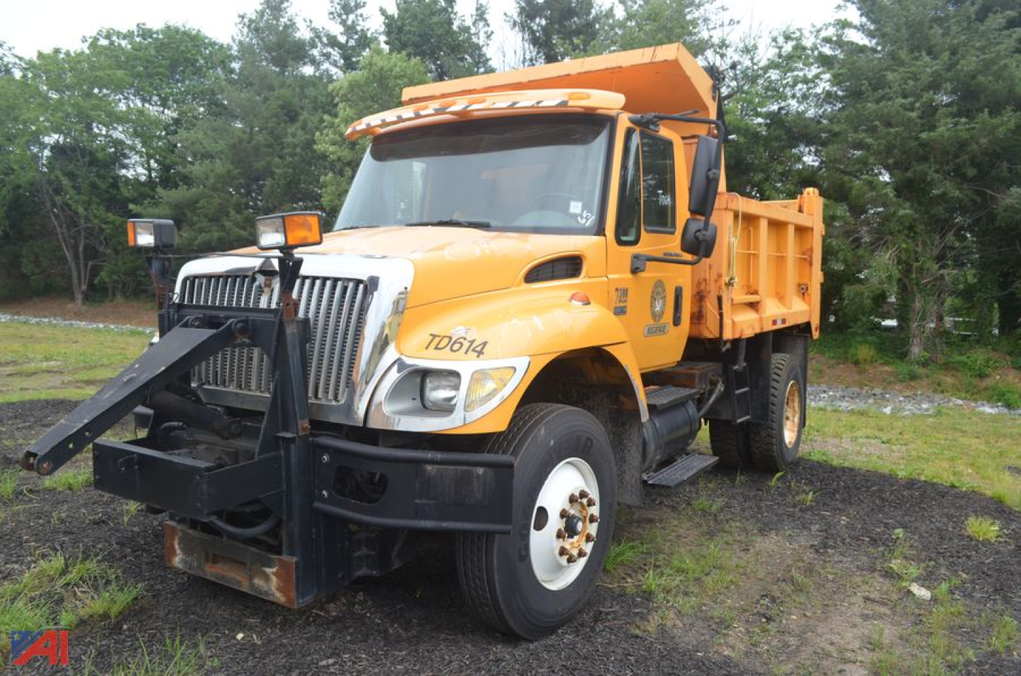 International WorkStar 7300 dump truck in-service showing front-mounted snowplow and dump bed with TD614 label