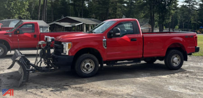 2017 Ford F-250 Super Duty pickup with plow attached, side view in red, two-tone accents, working truck in a yard.