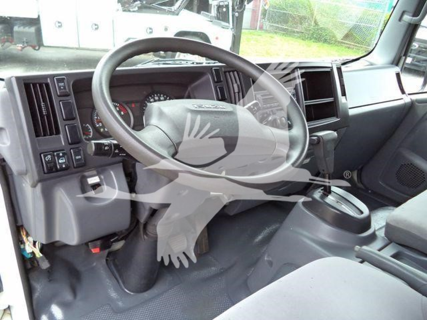Isuzu NPR HD interior showing steering wheel and dashboard view.