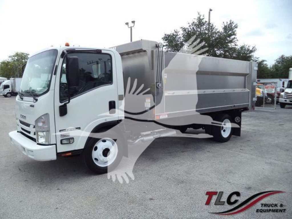 Isuzu NPR HD dump truck in a used lot showing cab and dump body with blank sides and white wheels.