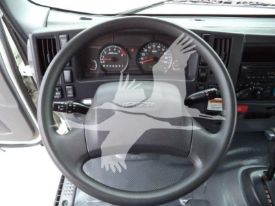 Isuzu NPR-HD truck cab dashboard with steering wheel, gauges, and control panel visible.