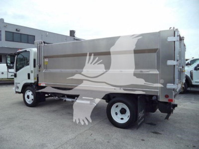 Isuzu NPR HD dump truck in side view showing cargo bed with logo and wheel, back and taillights visible.