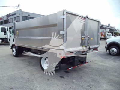 Isuzu NPR HD dump truck rear and side view showing metallic cargo bed and tailgate with latching hardware.