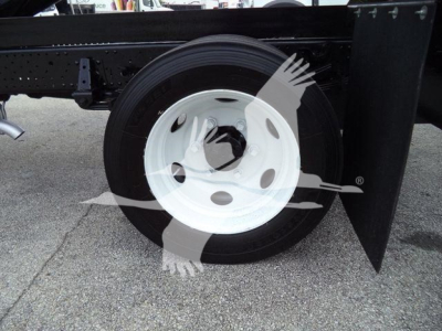 Isuzu NPR HD truck rear wheel and chassis with white steel rim and black tire.