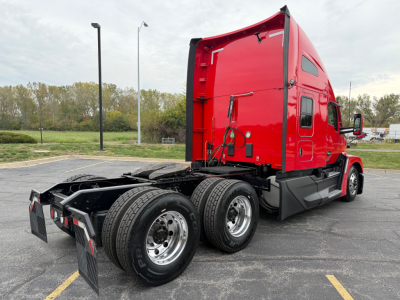 Kenworth T680 truck in red sleeper cab viewed from rear quarter with dual rear axles and fifth wheel, stock number 0635680, VIN 1XKYD49X1PJ229990.