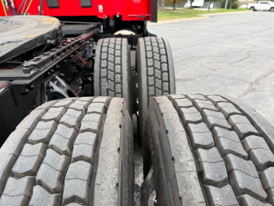 Kenworth T680 truck chassis with dual rear axles and large tires; tread pattern visible on left and right tires.