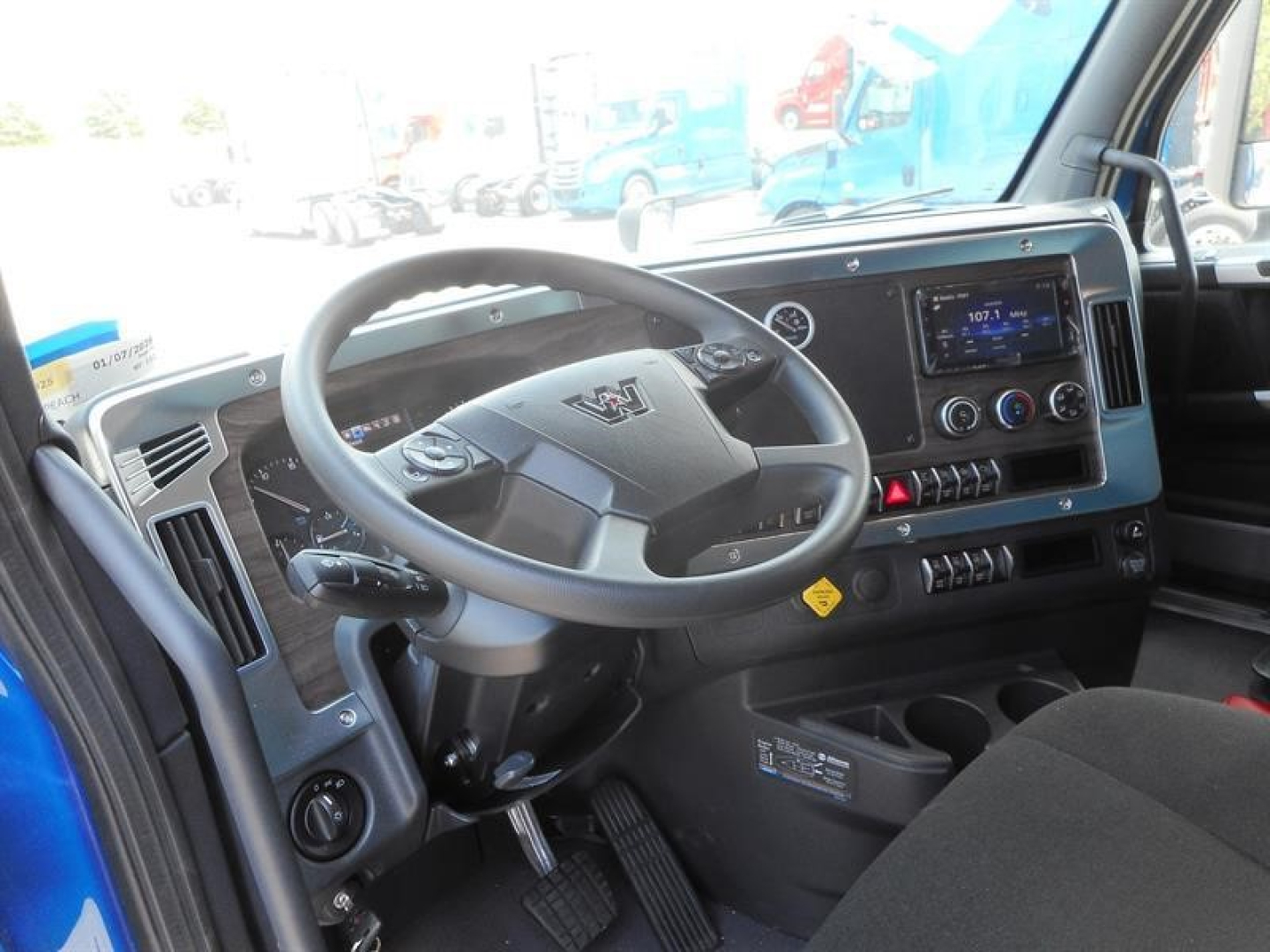 Dashboard and steering wheel of a Western Star 47X interior showing V-shaped steering wheel, digital display, and control panel.