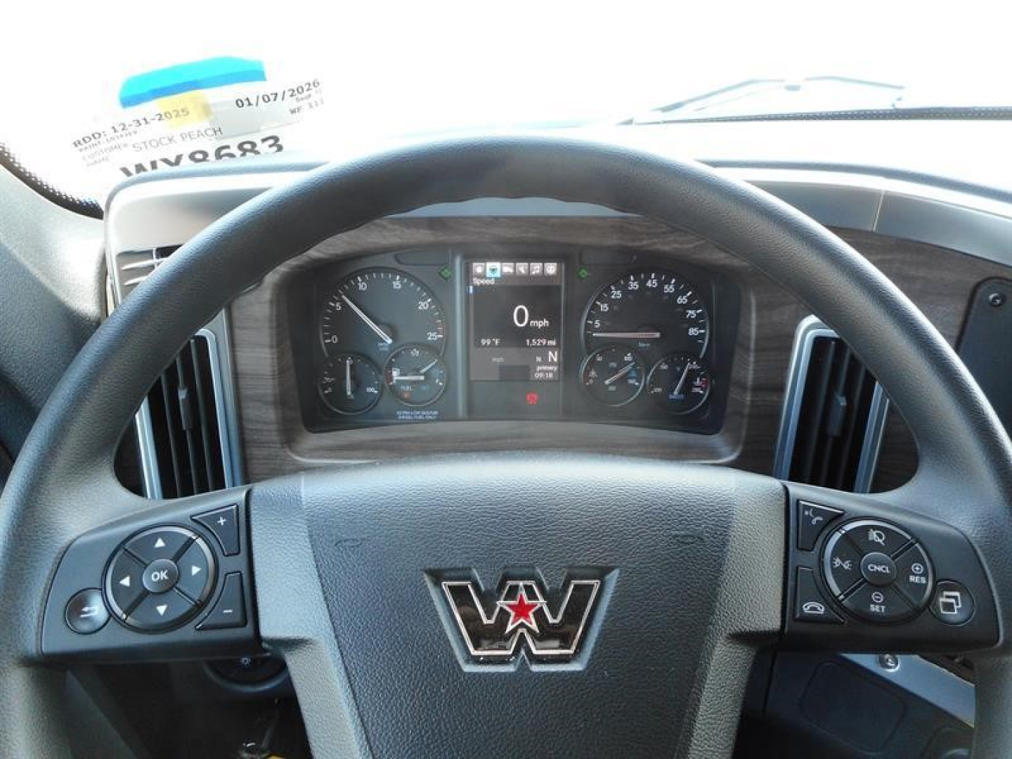 Western Star interior dash and steering wheel view showing instrument cluster and steering wheel controls.