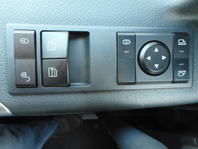Panel of a Western Star 47X truck showing window/lock controls and circular mirror adjustment pad.