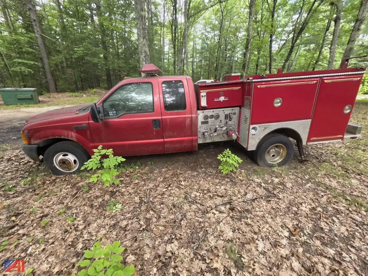 Ford F-350 Super Duty mini pumper truck side profile showing red engine compartment and silver pump panel with compartments.