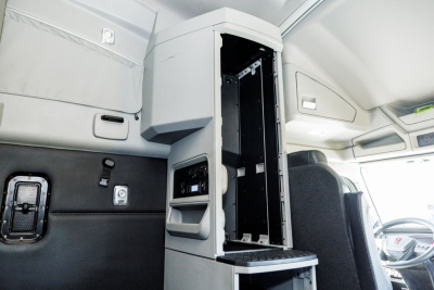 Kenworth T680 interior cab area showing center console open with storage compartments and dashboards