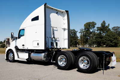 Kenworth T680 truck tractor in-profile showing sleeper cab, rear wheels, and fifth-wheel area.