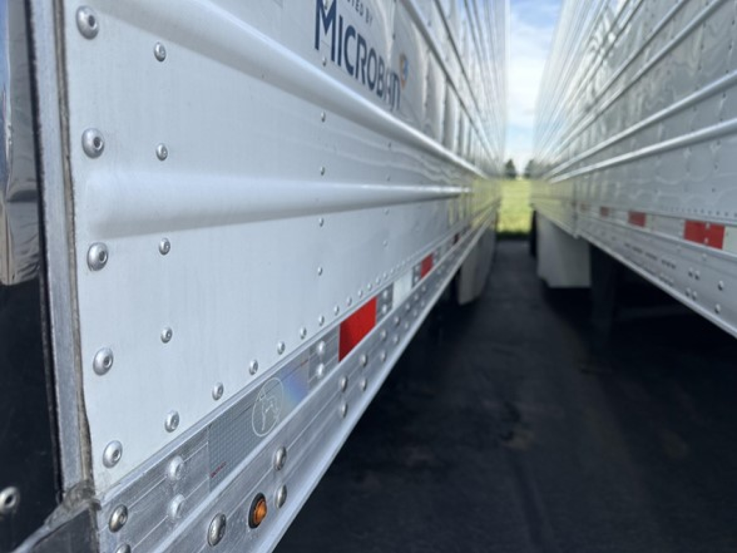 Great Dane air ride reefer trailer side view showing Microban logo and riveted aluminum siding with reflective diamond plate trim.