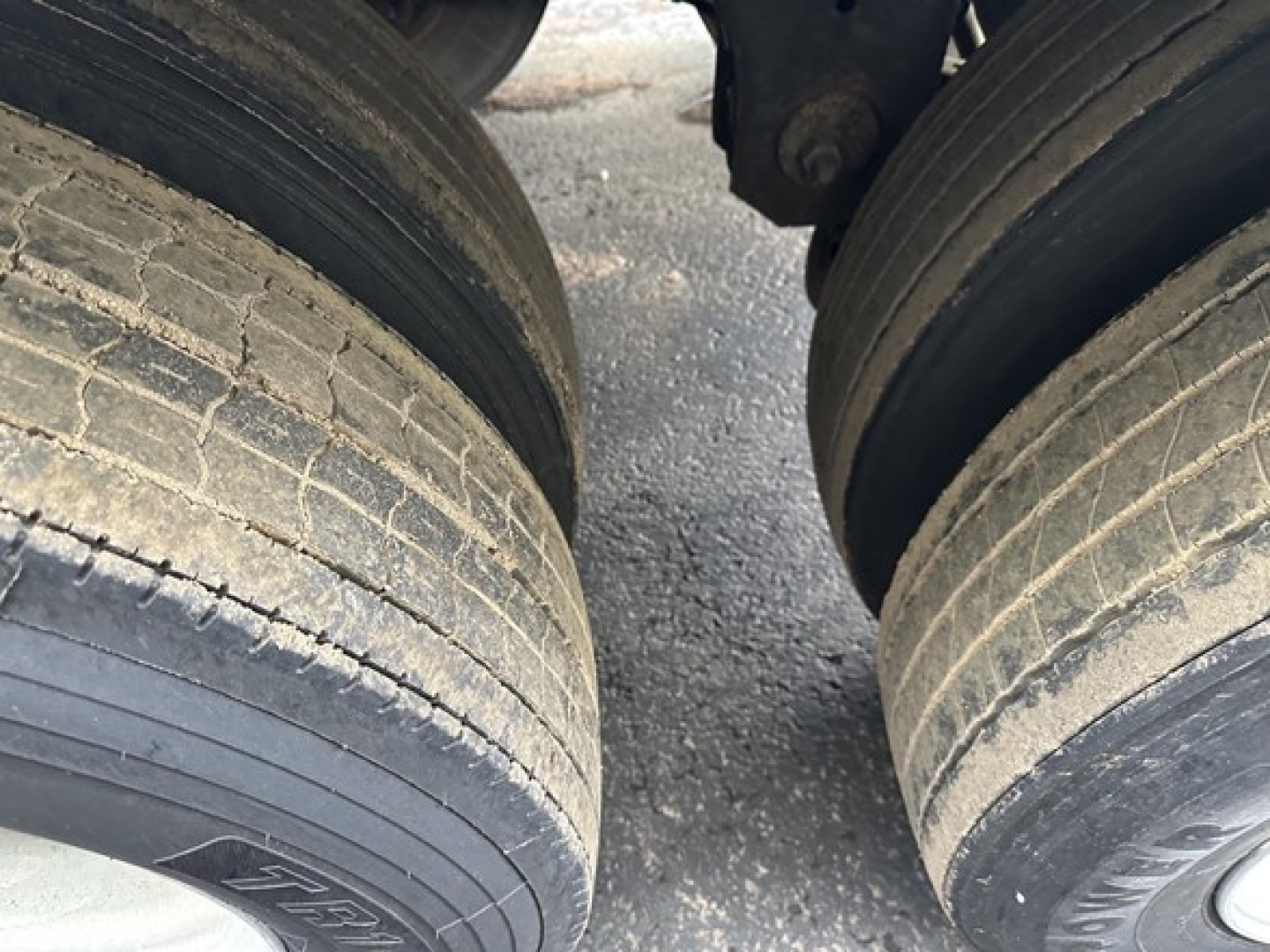 Great Dane air ride reefer trailer wheel pair showing worn tires and suspension area.
