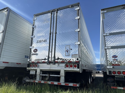 Rear view of a Great Dane air ride reefer trailer with diamond plate doors, rear bumper, taillights, and labels '239745' on the left door.