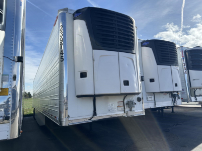 Great Dane air ride reefer trailer showing rear doors and refrigeration unit. Visible text on left rear edge: 2397455; side wall with ribbed aluminum; white exterior; cooling unit on top of doors.