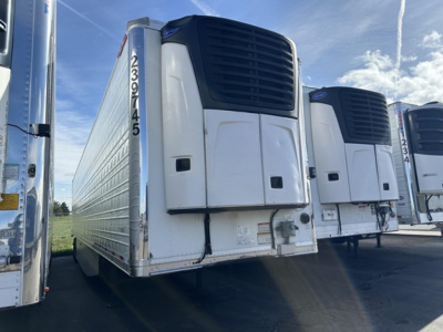 Great Dane air ride reefer trailer showing front refrigeration unit and side door, with VIN tag and stock number nearby.