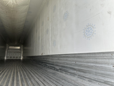 Trailer interior of a Great Dane air ride reefer with ribbed metal floor and insulated walls showing logos; empty cargo area.