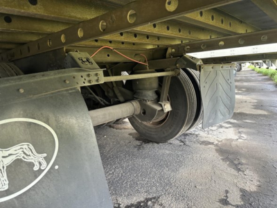 Great Dane air ride reefer trailer undercarriage showing suspension, wheel, and mudflap with animal logo.