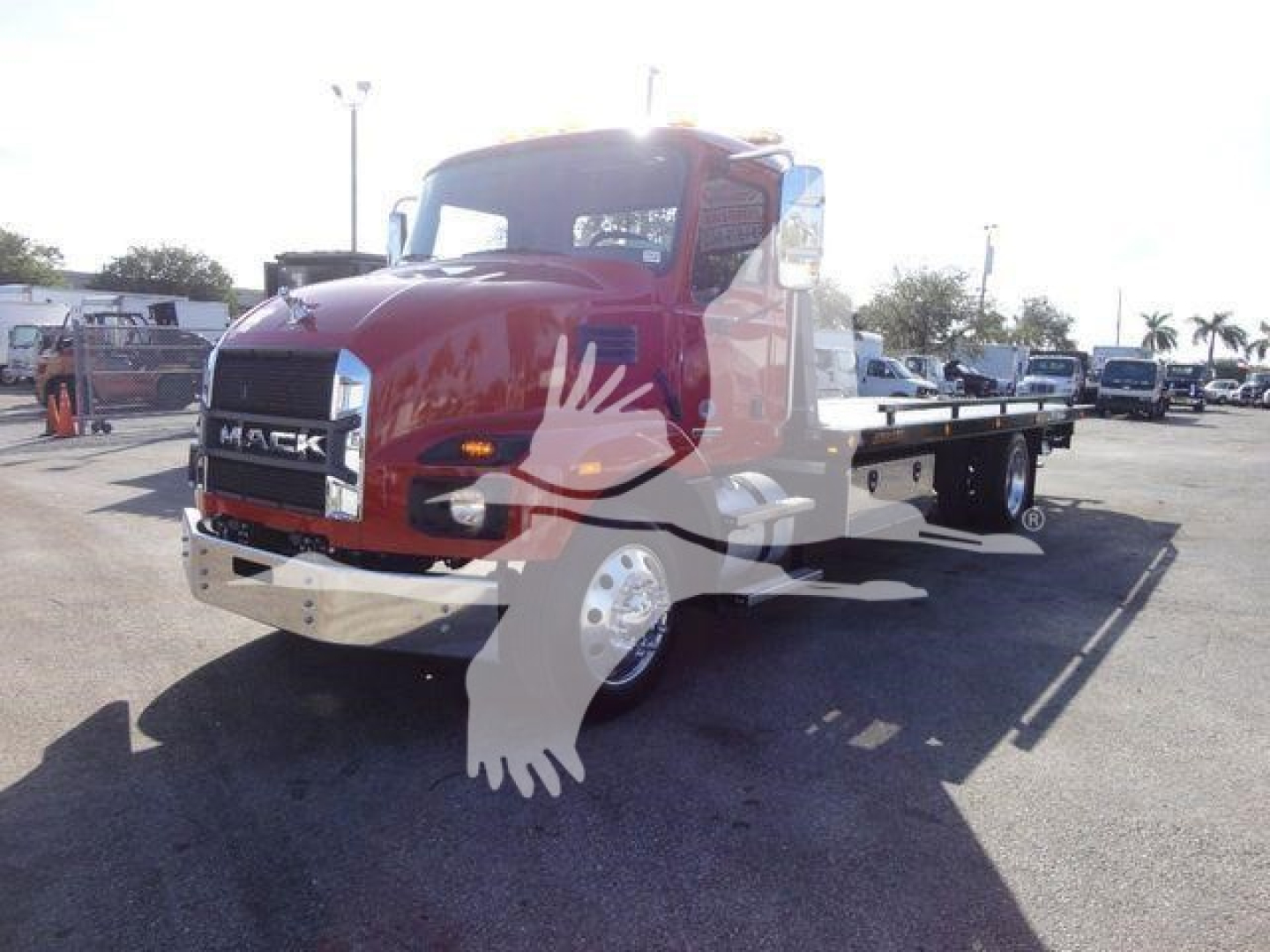 Front-left view of a maroon 2027 Mack MD6 rollback tow truck with flatbed, showing Mack grille and headlights.