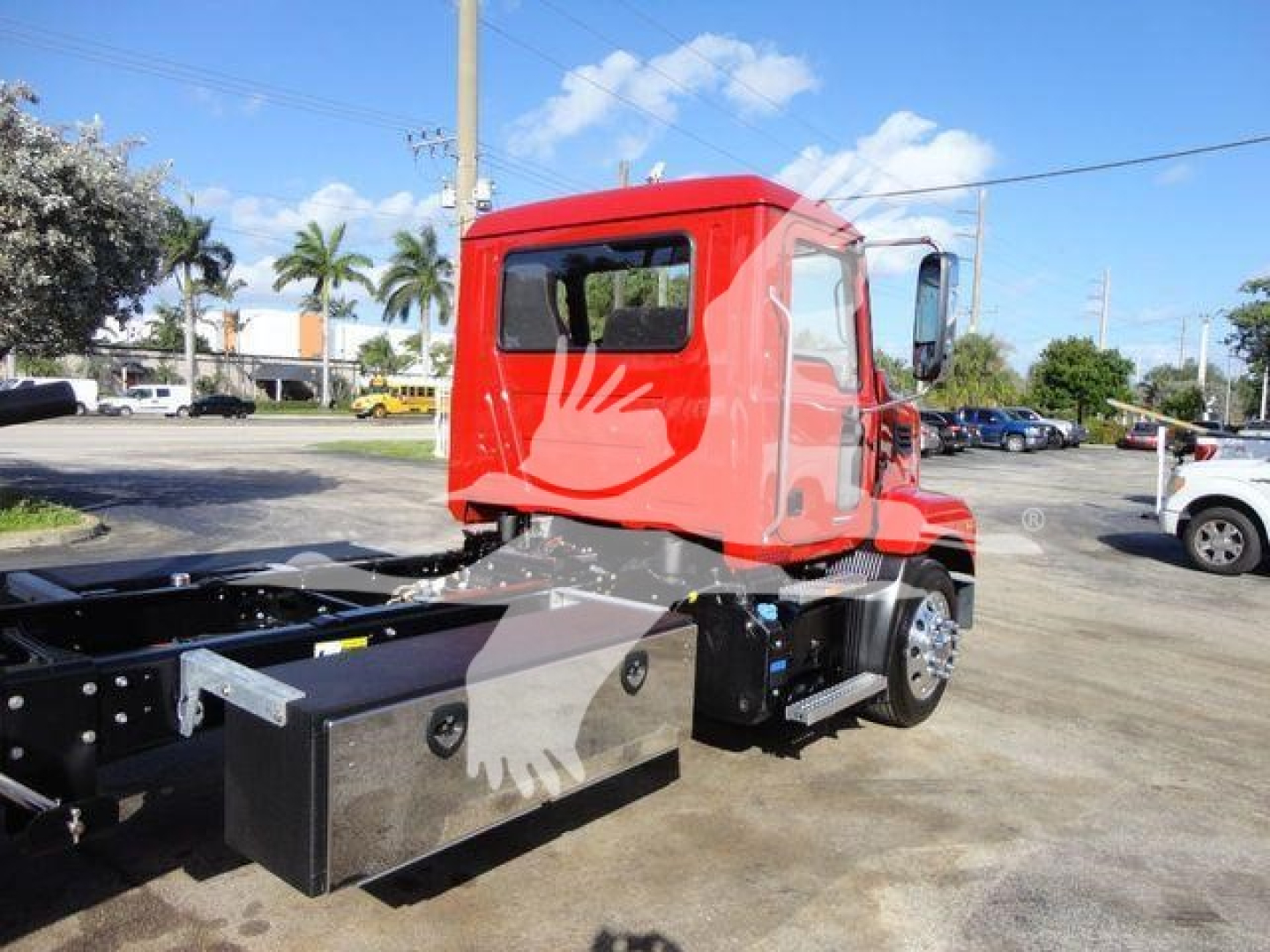 Mack MD6 truck chassis rear and cab view showing red cab and chassis frame with toolbox boxes