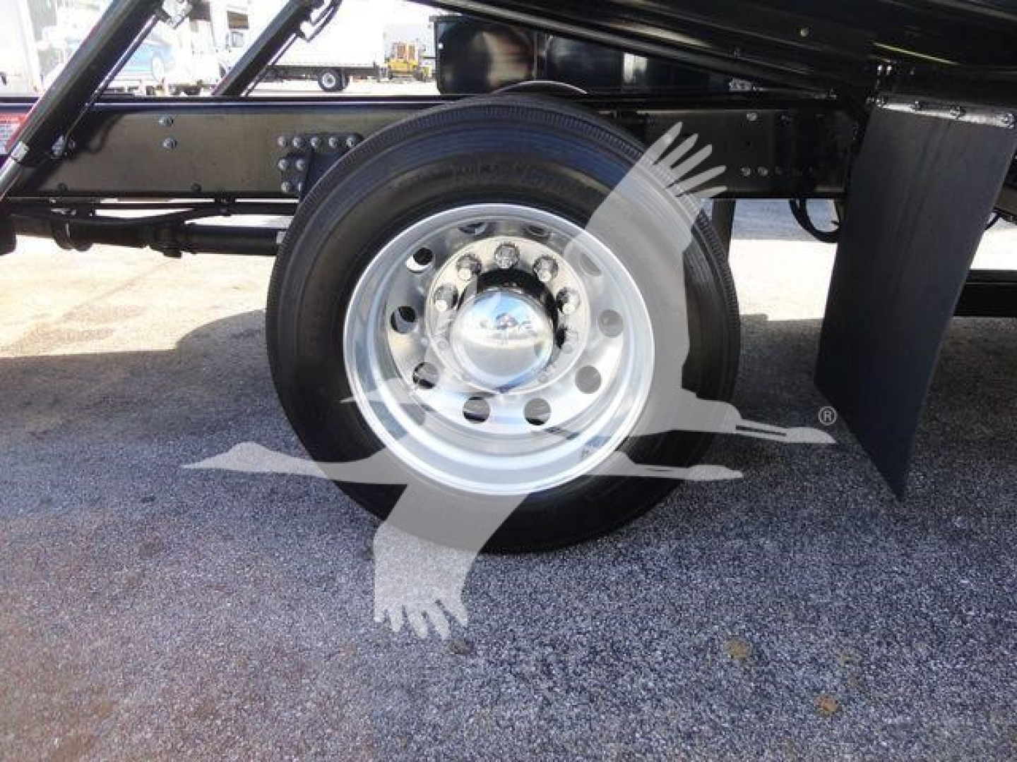 MD6 truck wheel and suspension side view showing front chrome wheel hub and black frame.