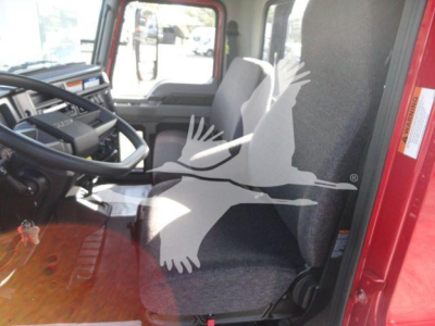 Cab interior of a 2027 Mack MD6 truck showing seating and steering wheel.
