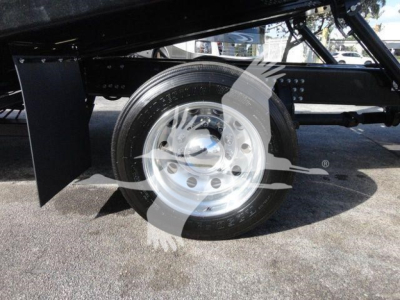 Mack MD6 chassis side view showing front wheel and suspension components with a polished steel wheel and black undercarriage.