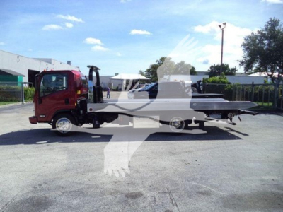 Isuzu NPR XD rollback truck with a white flatbed in view, side profile showing cab and bed.