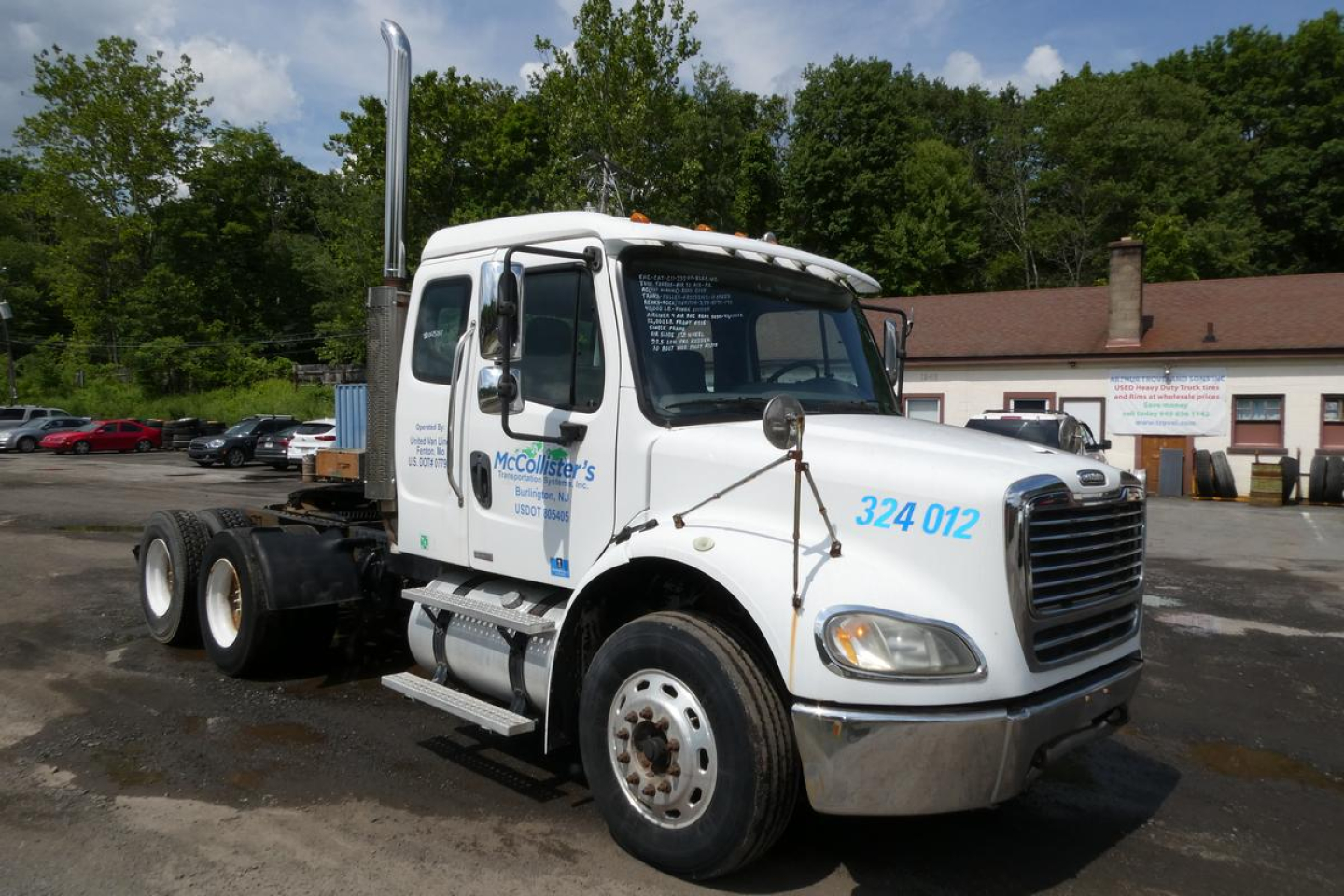 Freightliner M2 112 cab with attached chassis showing McCollister’s trucks logo and blue numbers on white cab.