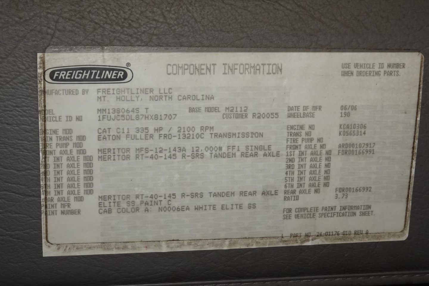 Freightliner component information plate inside cab showing vehicle model and technical specs including VIN and manufacturing data.