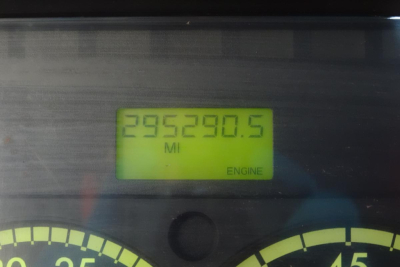 Dashboard odometer reading 295,290.5 miles in a Freightliner M2 112 context with engine indicator.