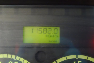 Instrumentation display showing hours on engine readout: 115,... Actually clearly reads 115, something. The visible digits: '11582.0 HOURS' with 'ENGINE' label below.
