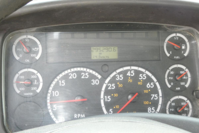 Dashboard of Freightliner truck showing analog gauges including RPM and speedometer, with digital odometer reading 295,380.6 and various scales for oil, water, fuel, PSI, and temperature.