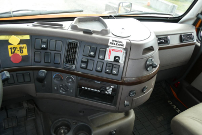 Volvo VNM64T cab interior dashboard and steering area with controls and vents visible.