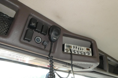 Volvo VNM64T interior ceiling console showing overhead control switches and radio/mic unit in cab.