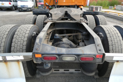 Rear view of Volvo VNM64T tractor chassis showing dual rear axles, fifth wheel, and bumper lights.