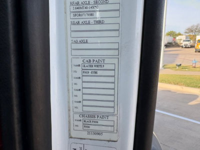 Vehicle door jamb label showing rear axle, cab paint, and chassis paint codes on a Volvo VNR truck.