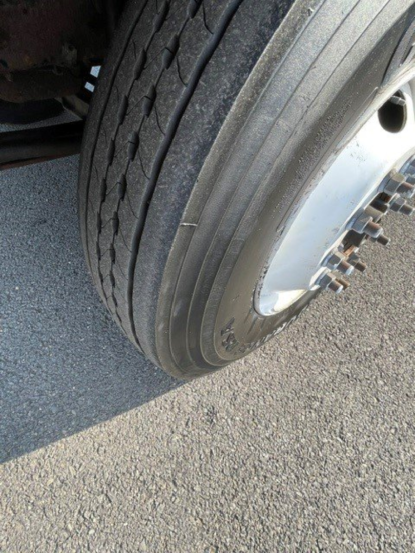Front wheel and tire of a 2017 Hino 268 box truck showing tread and wheel hub.