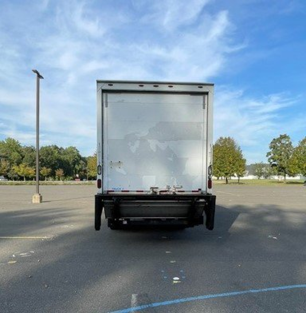 Truck rear showing box truck cargo area and rear bumper with taillights visible.