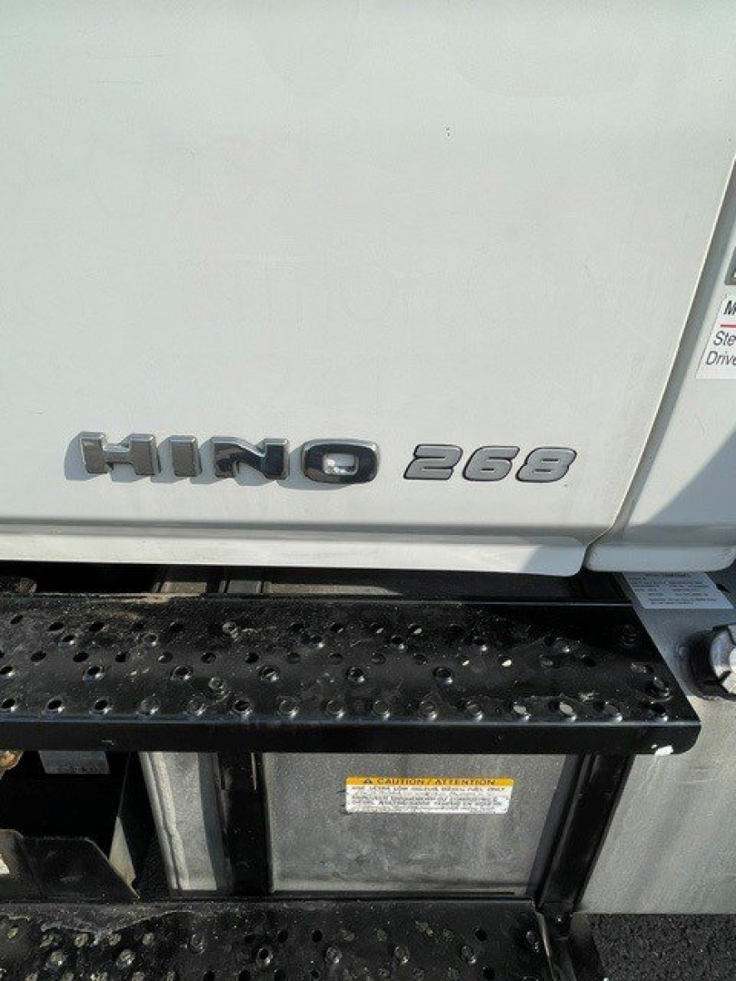 Hino 268 emblem on door of truck with step area below
