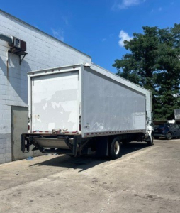 Hino 268 box truck rear/right side view showing cargo box and underrun protective bar.
