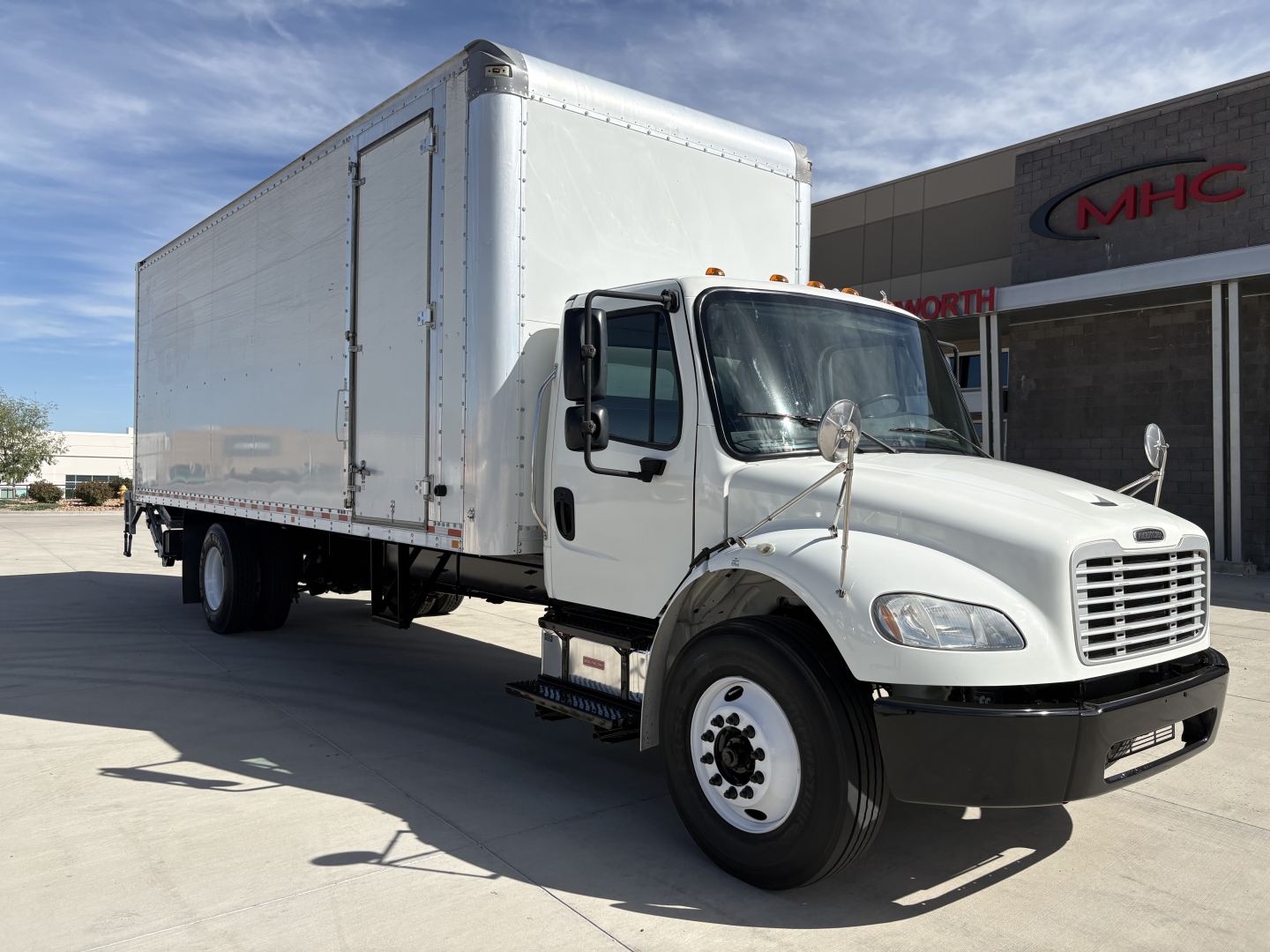 Box truck 2020 Freightliner M2-106 side view showing cab and box cargo area.