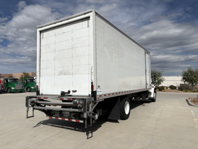 Freightliner M2-106 box truck rear/side view showing cargo box and rear underride guard.