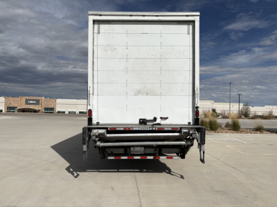 Freightliner M2-106 box truck rear view showing cargo area door with rear underride guard and bumper hardware.