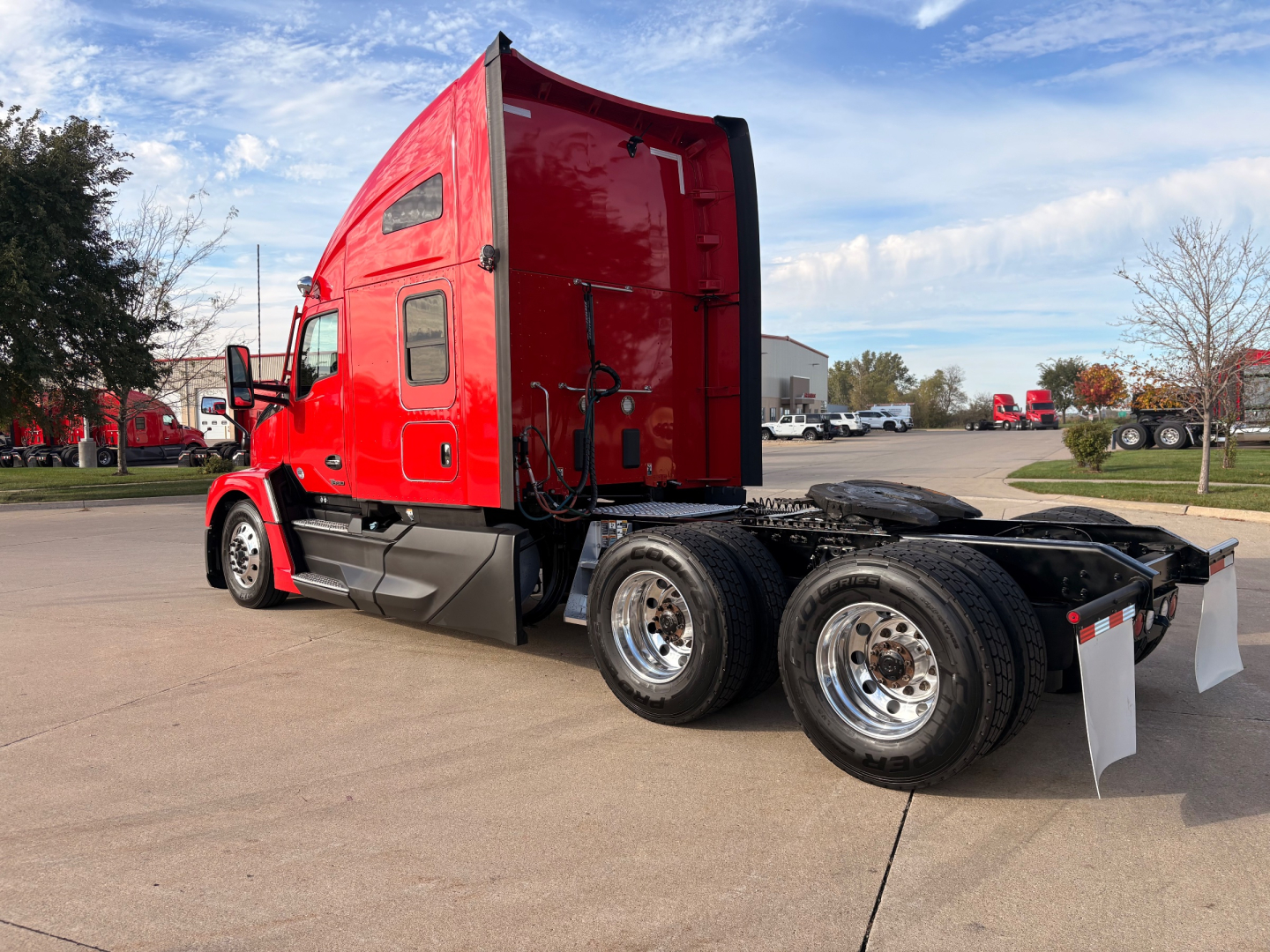 Kenworth T680 truck chassis with red sleeper cab, dual rear axles, and exposed wheels.