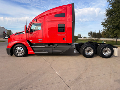 Kenworth T680 6x4 semi-truck cab in red, side profile showing sleeper cab, fuel tanks, and rear axles with chrome wheels.